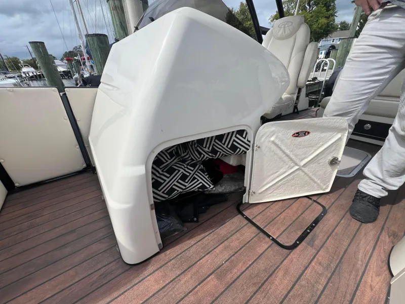 Slide: The Image of 2015 Harris FloteBote Grand Mariner SL 250 interior with open storage compartment. - 22