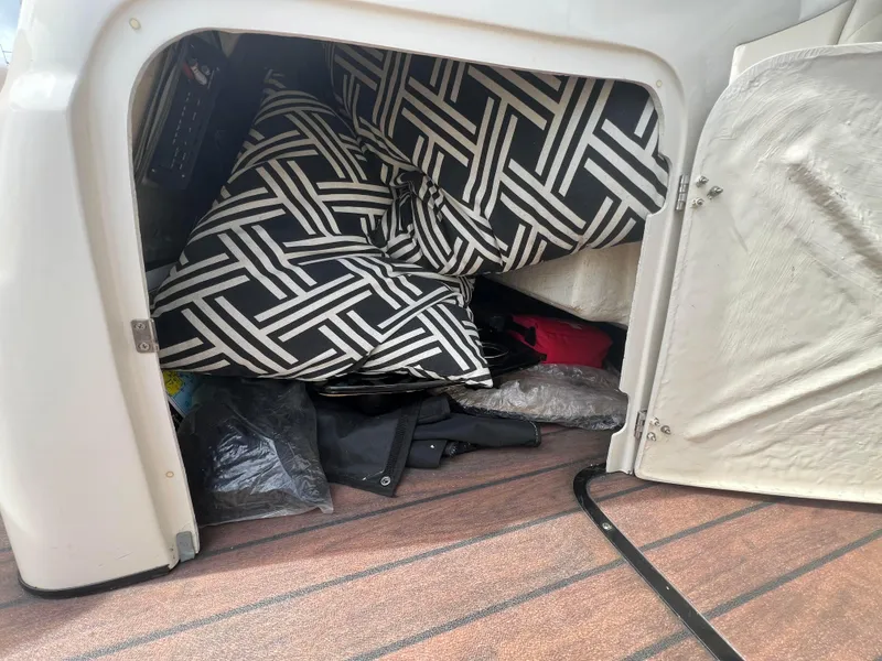 Slide: The Image of Storage compartment in 2015 Harris FloteBote Grand Mariner SL 250 with cushions and gear. - 23