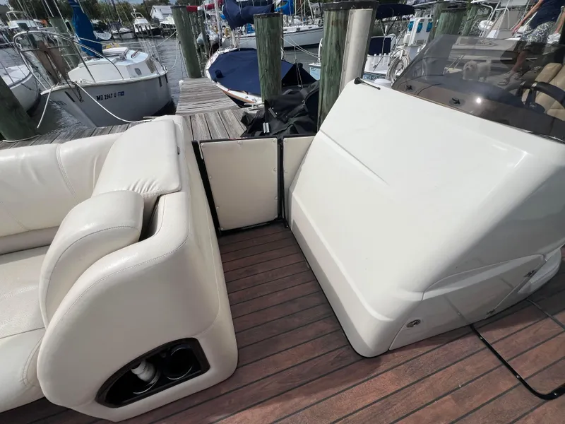 Slide: The Image of 2015 Harris FloteBote Grand Mariner SL 250 interior with white seating and wooden deck. - 24