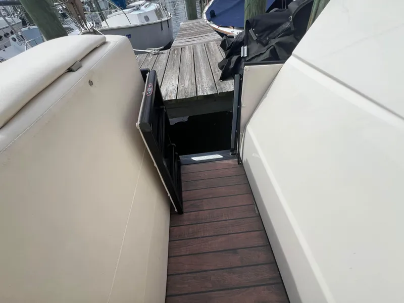 Slide: The Image of 2015 Harris FloteBote Grand Mariner SL 250 docked, showing deck and seating area. - 25