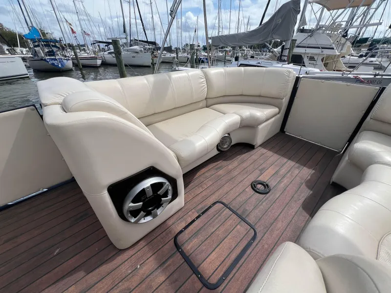 Slide: The Image of 2015 Harris FloteBote Grand Mariner SL 250 interior with beige seating and wood flooring. - 26