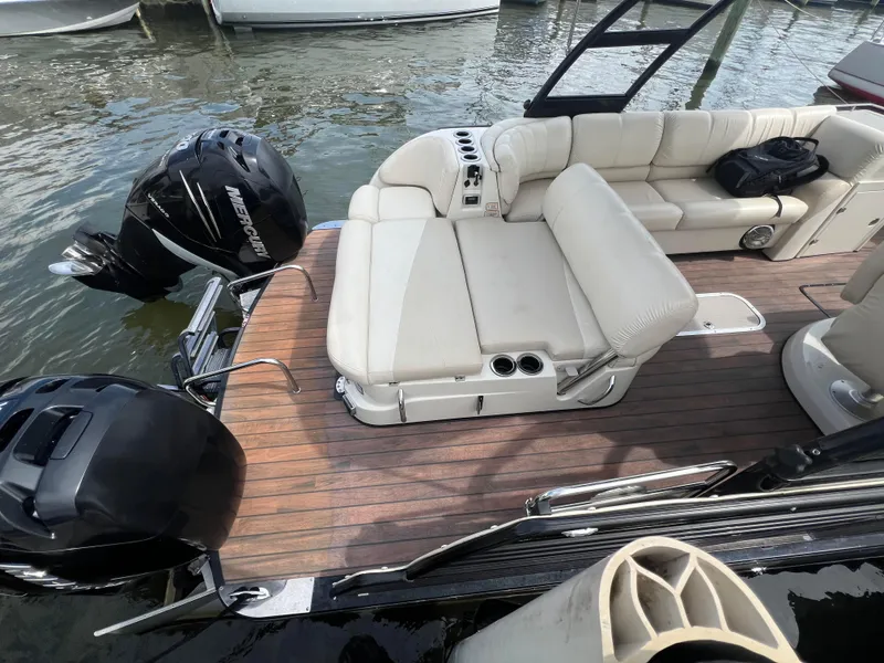 Slide: The Image of 2015 Harris FloteBote Grand Mariner SL 250 with Mercury engines, featuring spacious seating and wooden deck. - 31