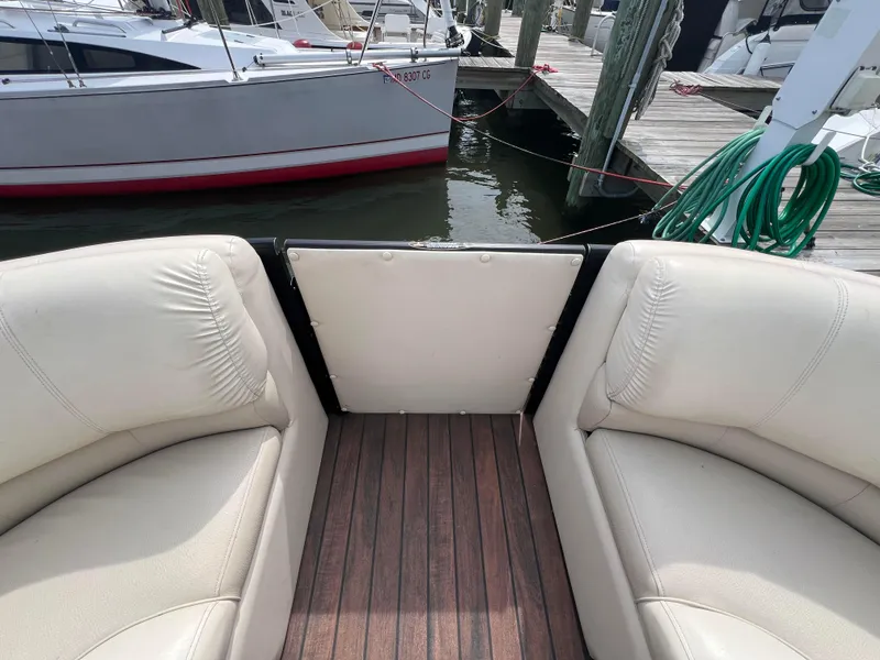 Slide: The Image of 2015 Harris FloteBote Grand Mariner SL 250 interior with white seating and wooden deck. - 36