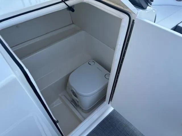 Slide: The Image of 2018 Bayliner VR6 Bowrider I/O boat interior with compact marine toilet. - 12