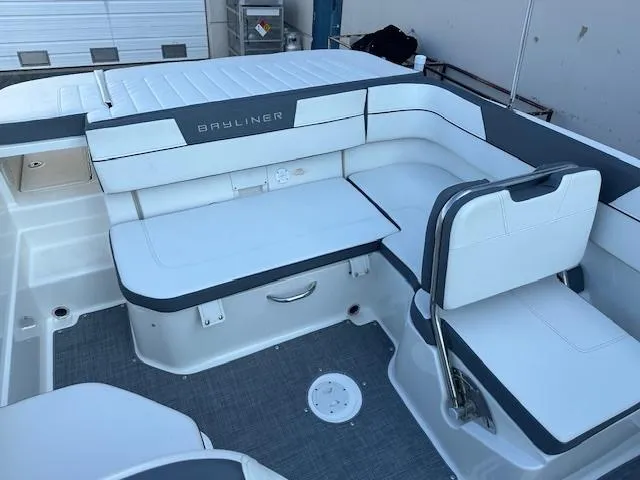 Slide: The Image of 2018 Bayliner VR6 Bowrider I/O interior with white seating and storage compartments. - 6