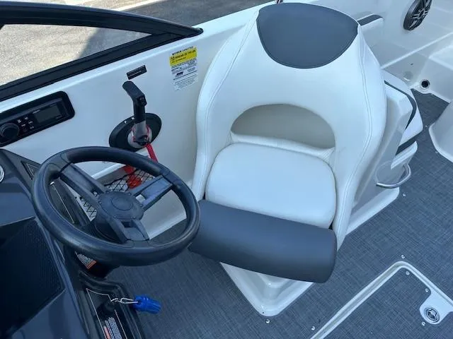Slide: The Image of 2018 Bayliner VR6 Bowrider I/O cockpit with steering wheel and white captain's chair. - 7