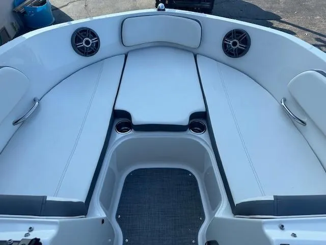 Slide: The Image of 2018 Bayliner VR6 Bowrider I/O interior with white seating and speakers. - 9