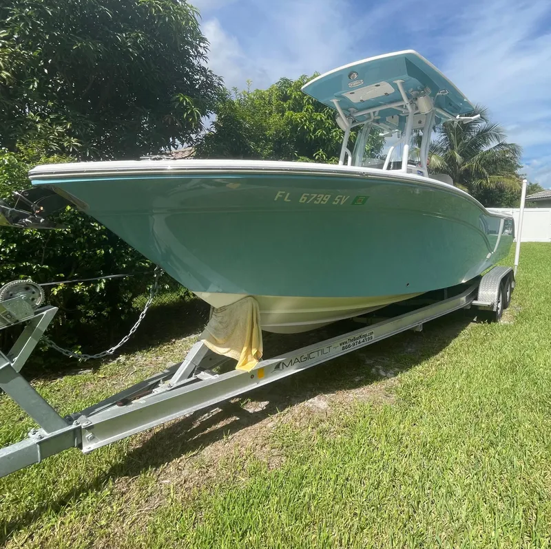 Slide: The Image of 2021 Sea Fox 248 Commander boat on trailer, parked on grass. - 1