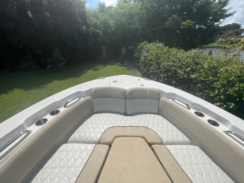 Slide: The Image of 2021 Sea Fox 248 Commander boat interior with cushioned seating and cup holders. - 4