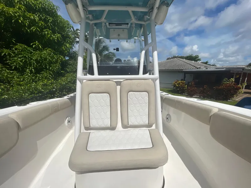 Slide: The Image of 2021 Sea Fox 248 Commander boat interior with cushioned seating under blue sky. - 5