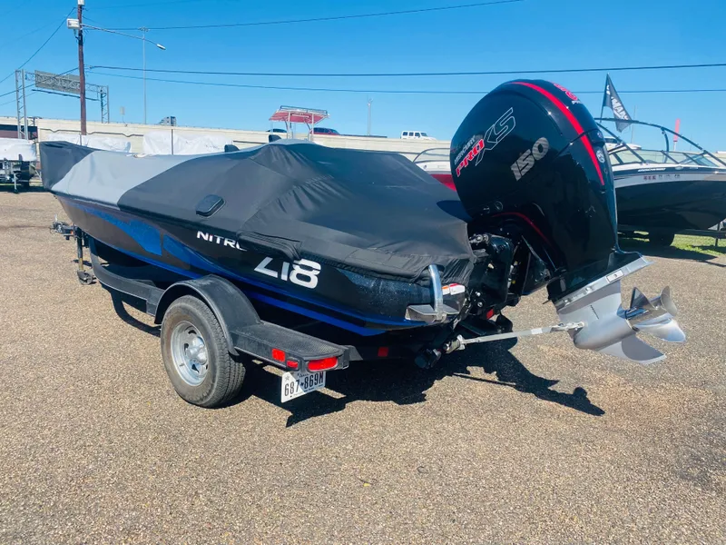Slide: The Image of 2023 Nitro Z18 boat with cover and powerful outboard motor. - 12