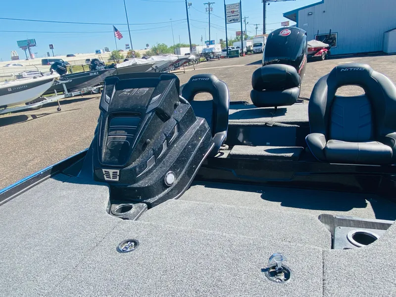 Slide: The Image of 2023 Nitro Z18 boat with sleek design and comfortable seating in a dealership lot. - 15