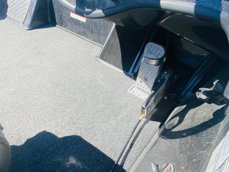Slide: The Image of 2023 Nitro Z18 boat interior with pedal and carpeted flooring. - 18