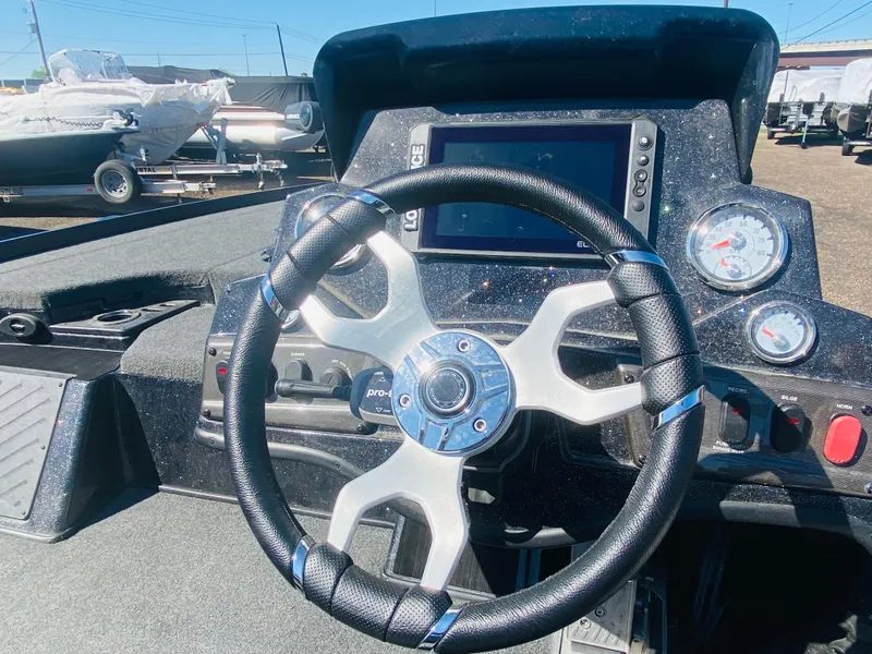 Slide: The Image of 2023 Nitro Z18 boat dashboard with steering wheel and gauges. - 19