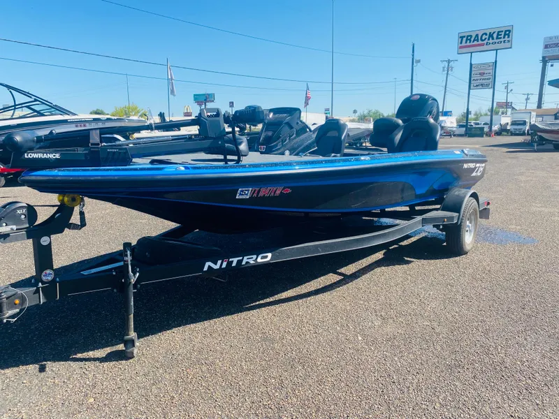 Slide: The Image of 2023 Nitro Z18 boat on trailer in outdoor dealership lot. - 2