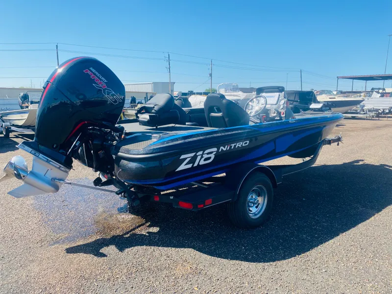 Slide: The Image of 2023 Nitro Z18 boat with powerful outboard motor in a sunny marina. - 4