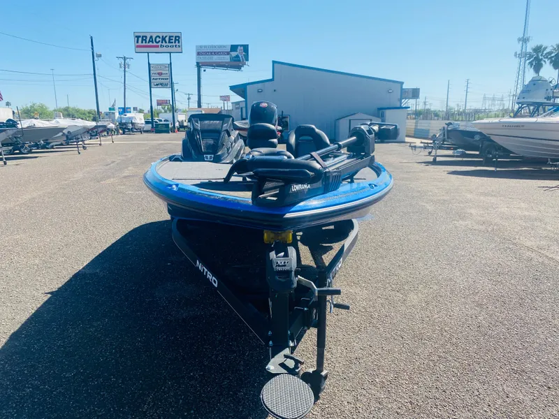 Slide: The Image of 2023 Nitro Z18 boat in dealership lot under clear blue sky. - 5