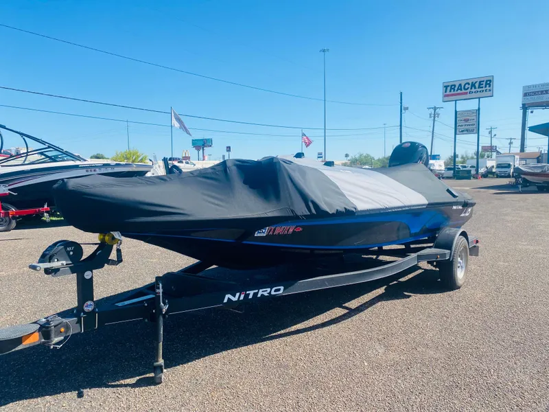 Slide: The Image of 2023 Nitro Z18 boat with cover on trailer in dealership lot. - 9