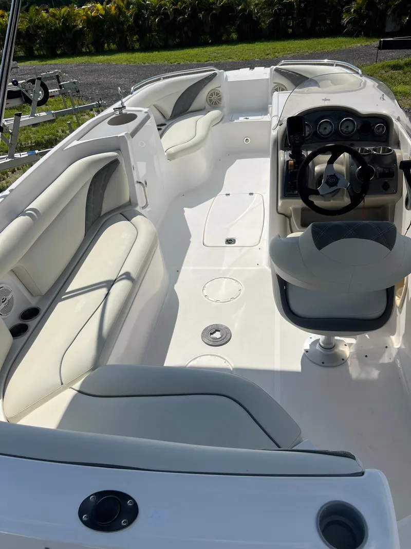 Slide: The Image of 2011 Hurricane SUNDECK SPORT 220 boat interior with seating and steering console. - 10