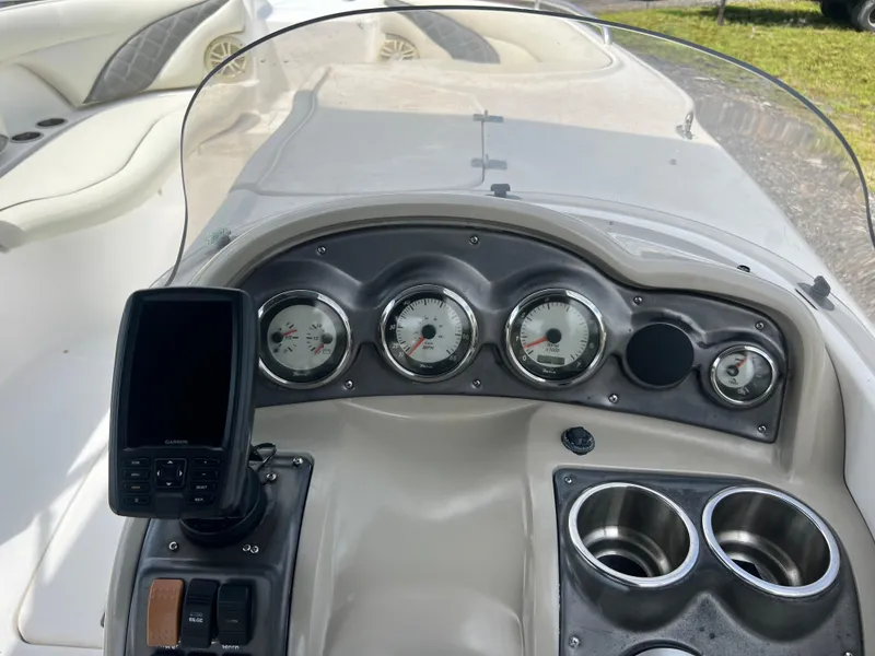 Slide: The Image of 2011 Hurricane SUNDECK SPORT 220 dashboard with gauges and cup holders. - 12