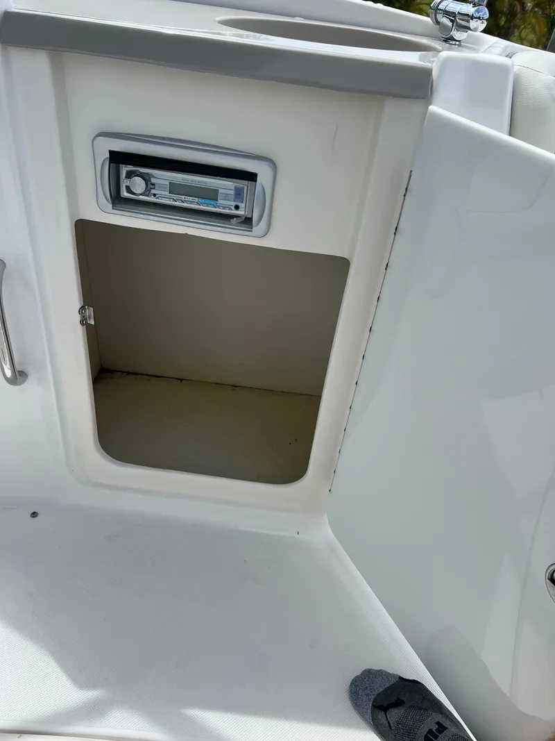 Slide: The Image of 2011 Hurricane SUNDECK SPORT 220 boat storage compartment with stereo system. - 15