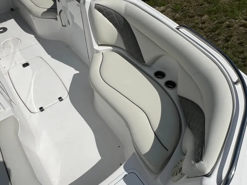 Slide: The Image of 2011 Hurricane SUNDECK SPORT 220 boat interior with white seating and cup holders. - 20