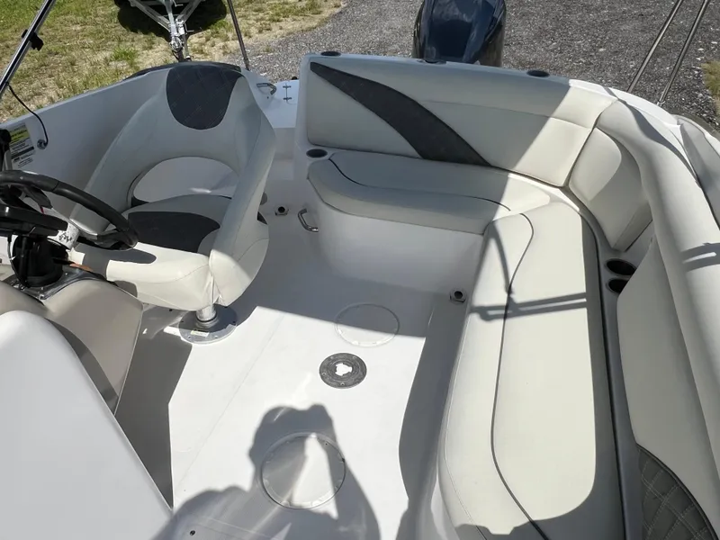 Slide: The Image of 2011 Hurricane SUNDECK SPORT 220 boat interior with white seating and steering wheel. - 22
