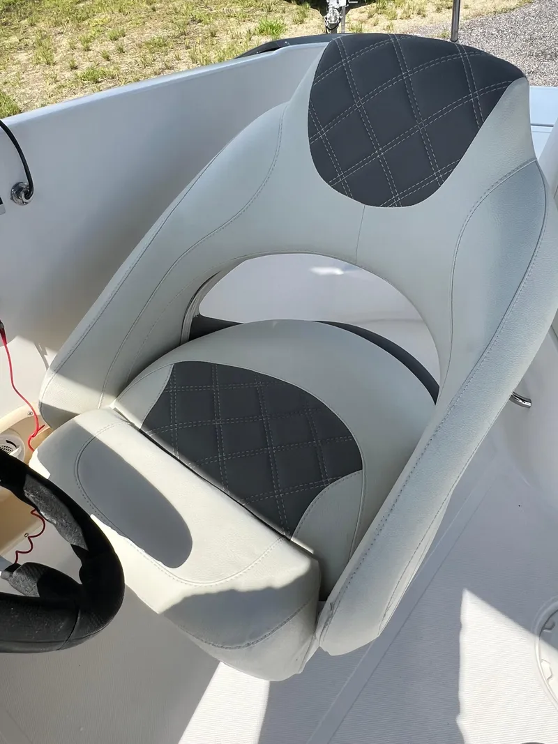 Slide: The Image of 2011 Hurricane SUNDECK SPORT 220 boat seat with gray and white upholstery. - 23