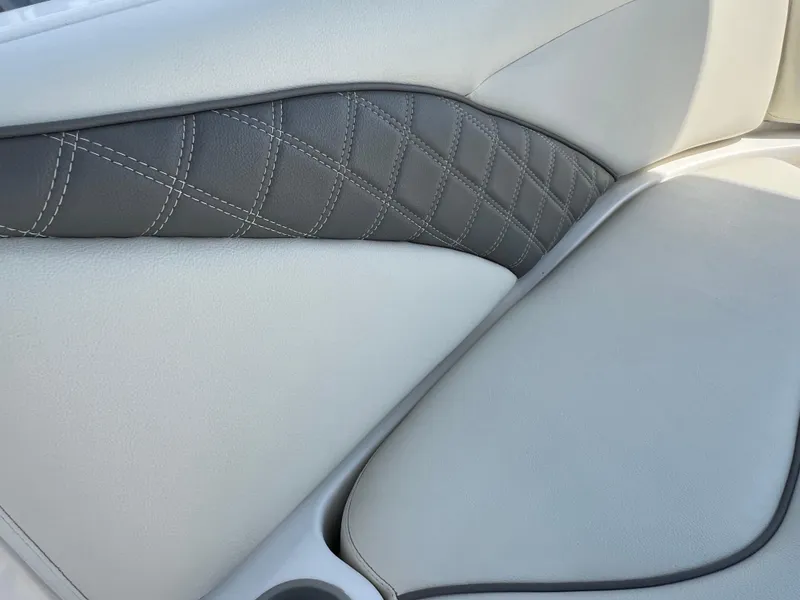 Slide: The Image of Close-up of 2011 Hurricane SUNDECK SPORT 220 boat seat with quilted gray and white upholstery. - 24