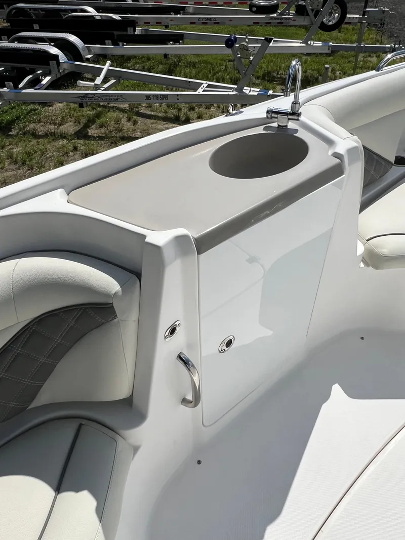 Slide: The Image of 2011 Hurricane SUNDECK SPORT 220 boat interior with sink and seating area. - 25