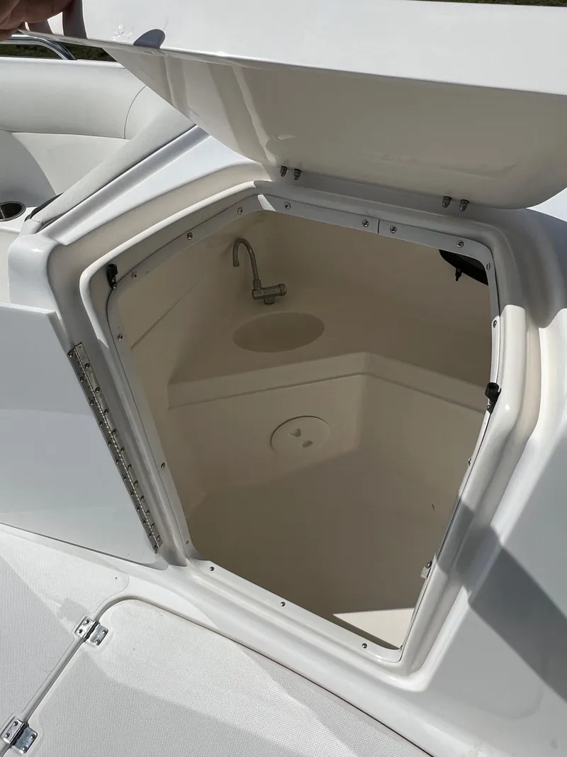 Slide: The Image of 2011 Hurricane SUNDECK SPORT 220 boat storage compartment with open hatch. - 27