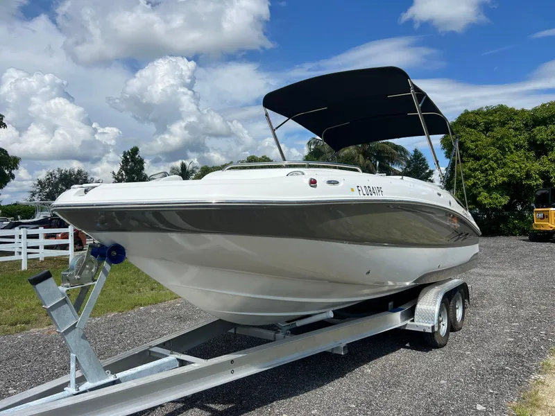 Slide: The Image of 2011 Hurricane SUNDECK SPORT 220 boat on trailer, parked outdoors under cloudy sky. - 3