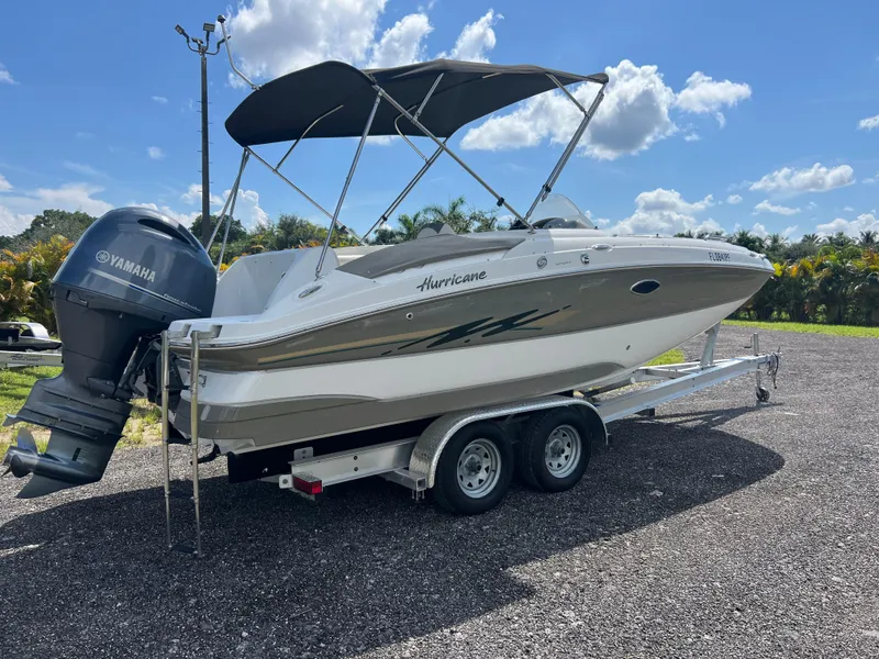 Slide: The Image of 2011 Hurricane SUNDECK SPORT 220 boat on trailer with Yamaha outboard motor. - 30