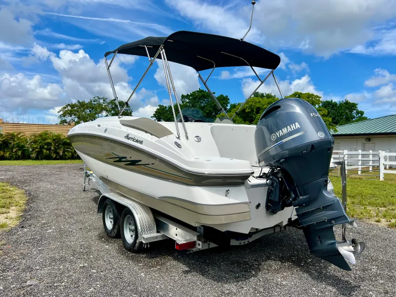 Slide: The Image of 2011 Hurricane SUNDECK SPORT 220 boat with Yamaha engine on trailer, outdoors. - 31