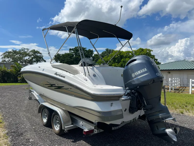 Slide: The Image of 2011 Hurricane SUNDECK SPORT 220 boat with Yamaha engine on trailer, outdoors. - 32