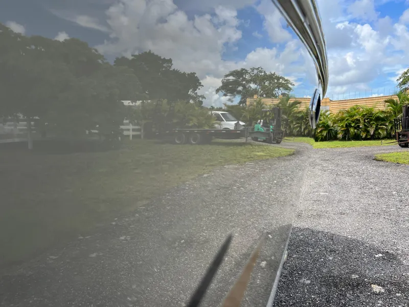 Slide: The Image of Reflection on 2011 Hurricane SUNDECK SPORT 220 boat, parked outdoors with trees and cloudy sky. - 8