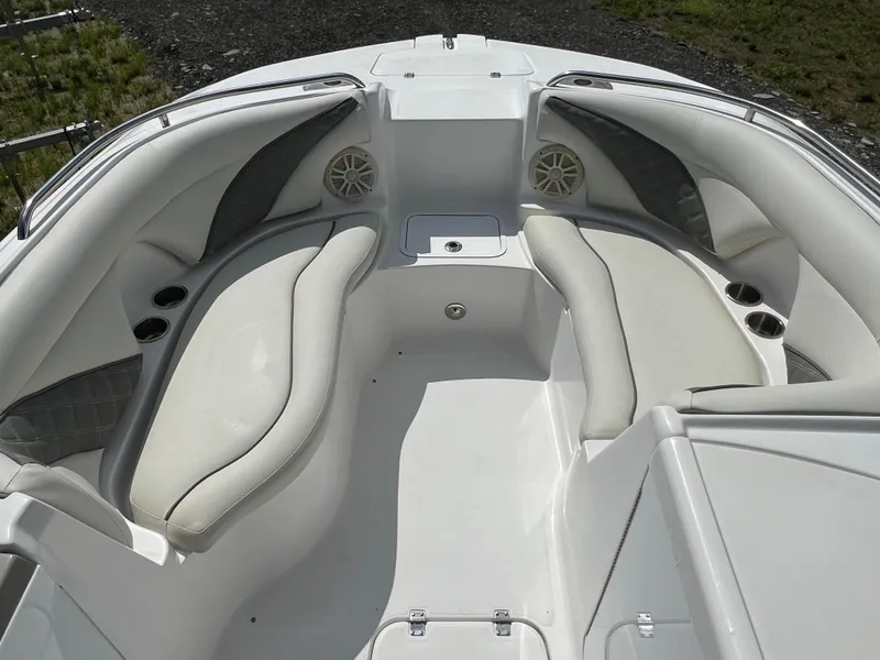 Slide: The Image of 2011 Hurricane SUNDECK SPORT 220 boat interior with white seating and cup holders. - 9
