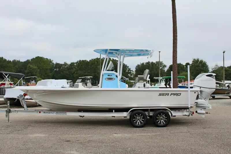 The Image of 2025 Sea Pro 250 Bay boat on trailer, side view, in a parking lot. - 0