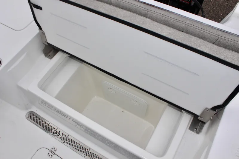 Slide: The Image of 2025 Sea Pro 250 Bay boat storage compartment with open lid. - 13
