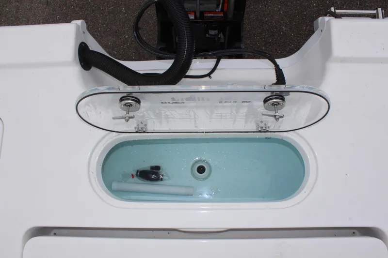 Slide: The Image of Livewell on 2025 Sea Pro 250 Bay boat, featuring a clear lid and plumbing. - 14