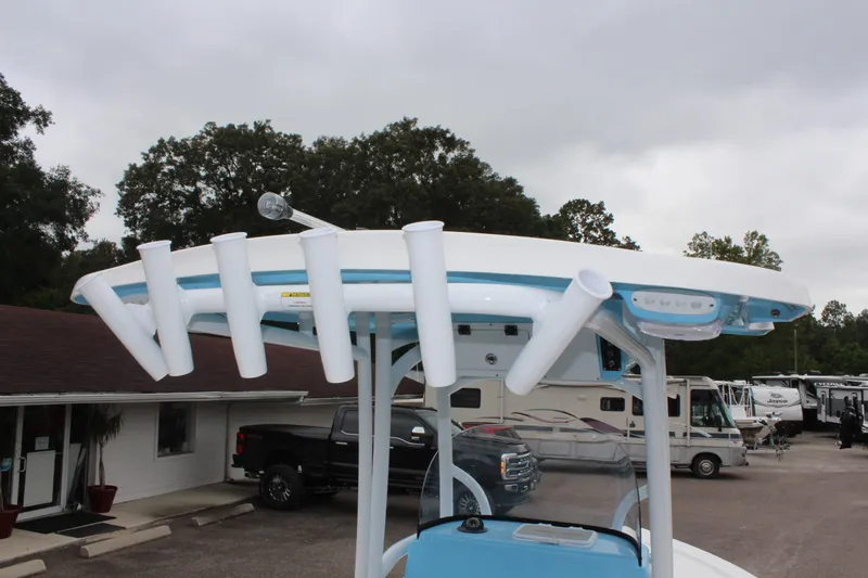 Slide: The Image of 2025 Sea Pro 250 Bay boat with rod holders and T-top in a parking lot. - 16