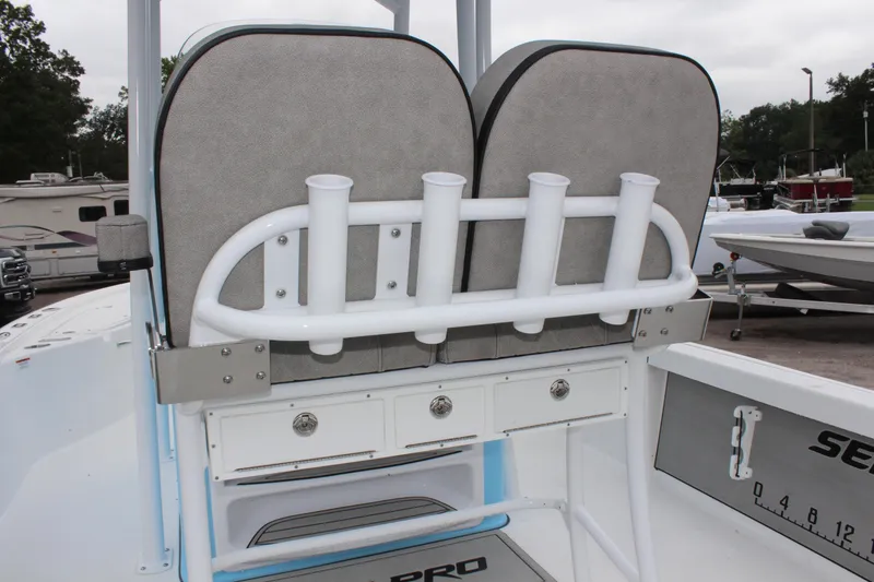 Slide: The Image of 2025 Sea Pro 250 Bay boat with rod holders and storage compartments. - 17