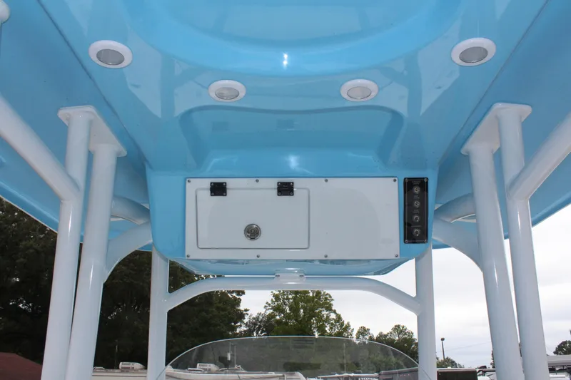 Slide: The Image of 2025 Sea Pro 250 Bay boat interior with blue ceiling and storage compartment. - 19