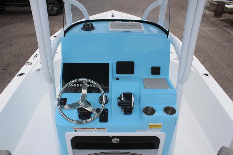 Slide: The Image of 2025 Sea Pro 250 Bay boat console with steering wheel and controls. - 20
