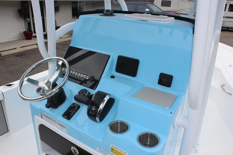 Slide: The Image of 2025 Sea Pro 250 Bay boat console with steering wheel and controls. - 22