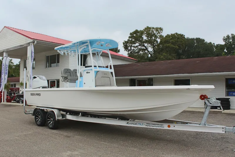 Slide: The Image of 2025 Sea Pro 250 Bay boat on trailer outside dealership. - 4