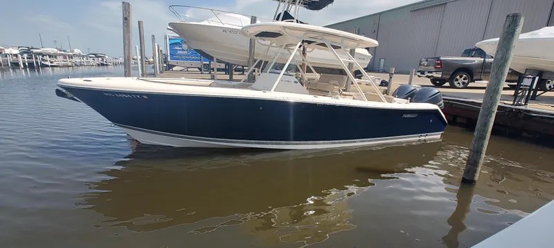 Slide: The Image of 2015 Pursuit S 280 Sport boat docked at marina, featuring sleek design and spacious deck. - 0