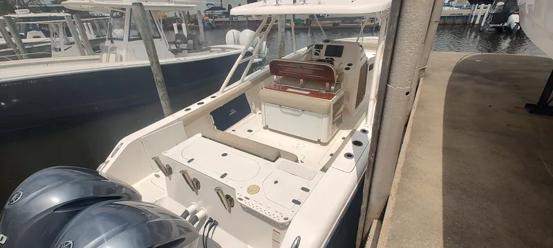 Slide: The Image of 2015 Pursuit S 280 Sport boat docked with dual engines and spacious deck. - 10