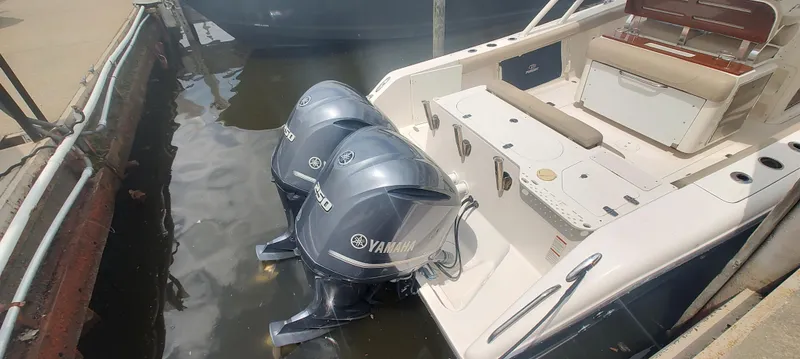 Slide: The Image of 2015 Pursuit S 280 Sport boat with twin Yamaha outboard engines docked in water. - 12