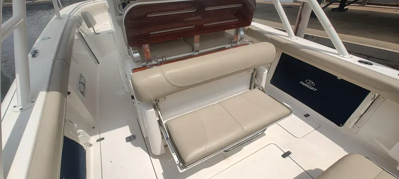Slide: The Image of 2015 Pursuit S 280 Sport boat interior with beige seating and sleek design. - 15
